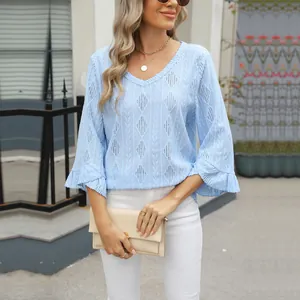 Women's light blue V-neck knit top featuring diamond eyelet pattern and bell sleeves
