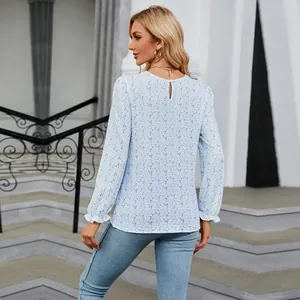 Back view of light blue floral print long sleeve blouse with keyhole button closure