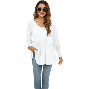Dettaglio della maglia peplum bianca con scollo a V e maniche a sbuffo arricciate