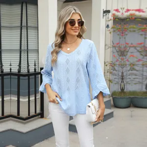 Detail of light blue V-neck t-shirt featuring diamond hollow knit and bell sleeves