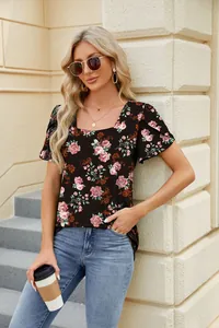 Detail view of a floral square neck t-shirt with petal sleeves in a stylish outdoor setting