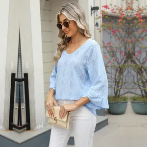 Detail of light blue V-neck top with diamond hollow-out jacquard and bell sleeves