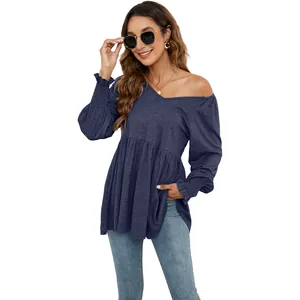 Dettaglio top blu scuro con scollo a V, maniche a sbuffo arricciate e vita sciancrata