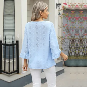 Back view of women's light blue hollow jacquard t-shirt with flared bell sleeves and diamond pattern