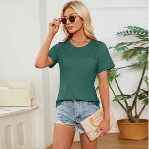 Close-up of a stylish green smocked crew neck t-shirt with elegant pleated details for women