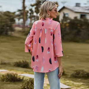 Detailed back view of pink loose shirt with colorful feather print and 3/4 sleeves