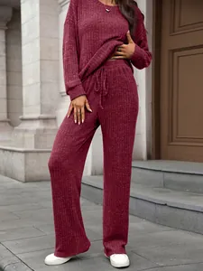 Detail of two-piece wine red ribbed knit loungewear set worn by a model outdoors