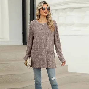 Close-up of mauve ribbed long sleeve tunic with functional front pockets and round neck.