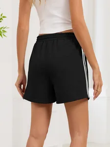 Detailed back view of women's black athletic shorts featuring white side stripes and elastic waist