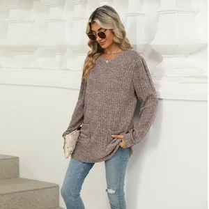 Close-up of a women's mauve ribbed knit top featuring puff sleeves and functional pockets
