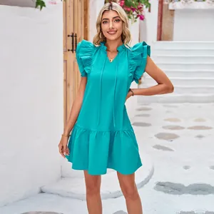 Elegant turquoise sleeveless dress with ruffle collar and pleated hem for summer fashion.