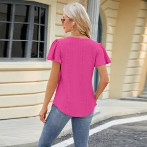Rear view of elegant magenta eyelet embroidered flutter sleeve top for women in street setting