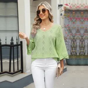 Close-up of women's V-neck green T-shirt with hollow diamond pattern and flare sleeves