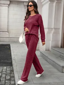 Elegant burgundy knit lounge set featuring a long sleeve top and wide leg pants