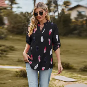 Stylish women's black V-neck shirt featuring a colorful feather print and loose 3/4 sleeves.