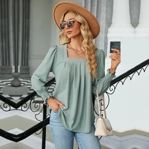 Detailed view of the jacquard texture and elegant pleated square neckline on this green top