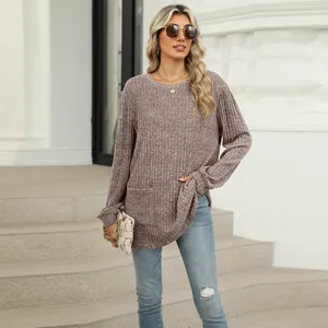 Close-up of a dusty rose rib-knit top with functional front pockets and puff sleeves.