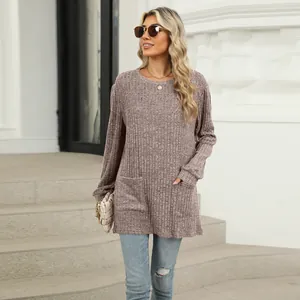 Detailed view of women's mauve ribbed knit loose top with front pockets and crew neck
