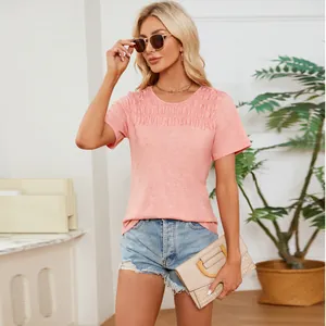 Close-up of pink smocked round neck t-shirt showing delicate pleated chest detail
