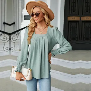 Detail view of elegant sage green jacquard square neck long sleeve top with pleated detail