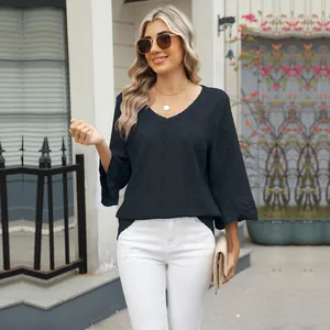 Detail view of stylish black V-neck top featuring hollow jacquard diamond patterns.