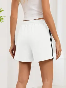 Rear view of white athletic shorts with black side stripes and elastic waist