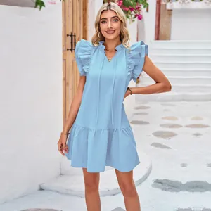 Light blue ruffle sleeve mini dress with tiered hem and v-neck tie in street setting