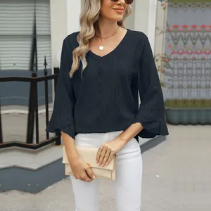 Detail of V-neck loose T-shirt featuring diamond hollow jacquard and flare sleeves.