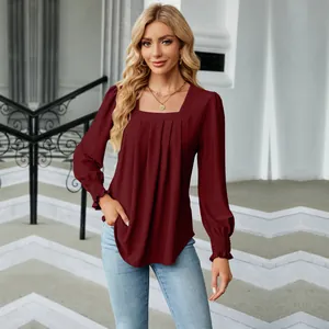 Detail view of stylish burgundy women's long sleeve blouse with pleated square neck design