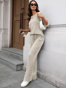 Elegant beige rib-knit loungewear set featuring long-sleeve round neck top and wide-leg pants