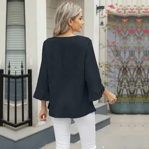 Detail of loose navy blue t-shirt with diamond jacquard hollow pattern and flare sleeves
