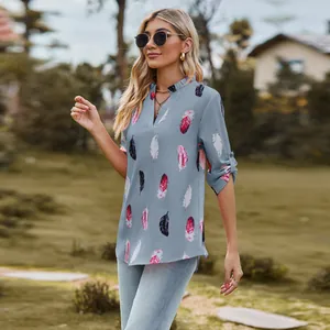 Detail view of a woman wearing a V-neck shirt with feather print and 3/4 sleeves