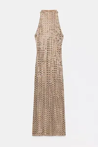 Detail view of a halter neck midi dress featuring a beige mesh grid with silver sequins.