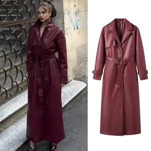 Elegant wine red faux leather long trench coat with belt and lapel collar detail.
