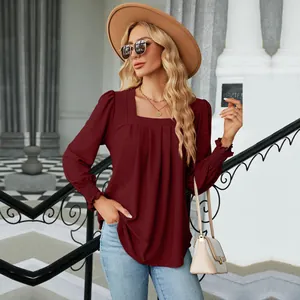 Close-up of wine red jacquard top featuring pleated front and square neckline details