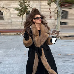 Elegant long black woolen coat featuring luxurious brown faux fur collar and slimming belted waist