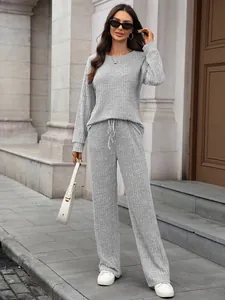 Detail view of a grey knitted long-sleeve loungewear set with ribbed texture details
