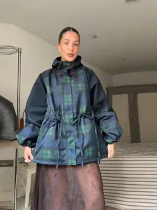 Full view of women's plaid hooded windbreaker jacket with drawstring waist