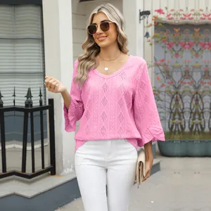 Detail of women's pink V-neck top with diamond jacquard knit and bell sleeves