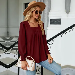 Close-up of burgundy square neck jacquard pleated blouse with elastic cuffs