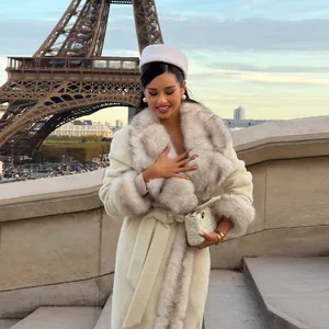 Elegant long off-white wool coat with luxurious fur collar and cuffs in Paris scene.