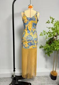 Elegant bohemian style floral print sleeveless dress featuring a dramatic long gold tassel hem