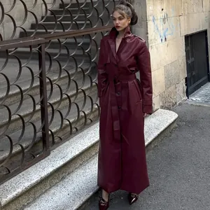 Elegant long burgundy faux leather trench coat with lapel collar and waist belt detail