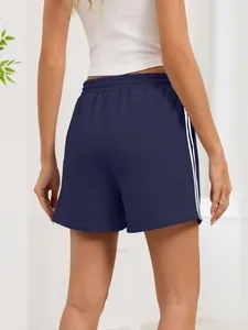 Detailed rear view of navy blue athletic shorts with double white side stripes and elastic waist