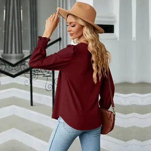 Back view of elegant burgundy jacquard pleated long sleeve blouse with ruffled cuffs