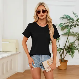 Close-up of black smocked round neck short sleeve t-shirt with pleated chest.