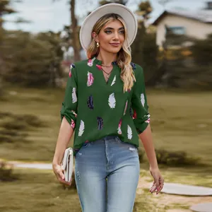 Elegant green V-neck blouse with feather print and adjustable sleeves for women fashion.