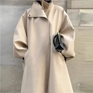 Close-up of beige stand collar long trench coat with stylish batwing sleeve design