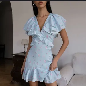 Elegantes hellblaues Kleid mit Blumenmuster, V-Ausschnitt und Rüschen für den Sommer