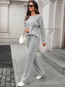 Chic grey ribbed knit lounge set featuring long sleeve top and wide leg trousers for women